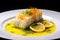 a side view of a beautifully plated baked cod dish with lemon