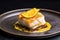 a side view of a beautifully plated baked cod dish with lemon
