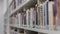 Side view on a bookshelf filled with books.