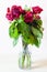 Side view of bouquet of wilted red roses in vase
