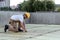 side view of builder in protective googles and hardhat working