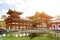 Side view of Byodoin Japanese Buddhist temple with bridge and many tourists come