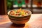 side view of cactus salad with crispy tortilla strips in a terracotta bowl