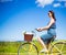 Side view of carefree beautiful woman riding vintage bicycle