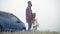 Side view of Caucasian bearded young father stroking hair of little daughter admiring beauty of misty landscape outdoors