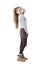 Side view of charming stylish hipster girl holding long hair in tail posing at camera.