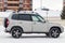 Side view of a Chevrolet Niva, a Russian-American car in the snow in winter