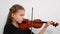 Side view child playing violin, studio shot