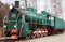 Side view of classic old green soviet steam locomotive with red star