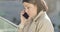 Side view close-up face of upset Caucasian woman talking on the phone and crying. Pretty stressed businesswoman having