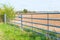 Side view of closed farmland metal gate in England