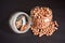 Side View of Closeup Peanuts-Groundnut in a Open Transparent Glass jar On isolated Black Background