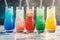 Side view of colorful iced drinks in various flavors, casting playful reflections