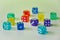Side view of colourful dices laying in white background