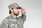 side view of confident bearded soldier in military uniform saluting