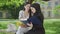 Side view of confident young students studying outdoors on sunny day. Portrait of positive Muslim and Caucasian women