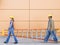 Side view of construction workers carrying ladder