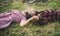 Side view couple lying on grass and looking at sky. Young people relaxing in park or forest. Summer holiday romance