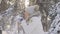 Side view cute girl in warm winter clothes throws snow up and laughs cheerfully. Beautiful blurred background of snowy