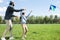 side view of daughter and father flying kite