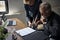 Side view of elderly man sitting on wheelchair looking at life insurance contract form