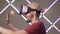 Side view of excited young man in VR-glasses touching invisible wall. Close-up of cheerful smiling gamer in virtual