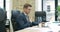 Side view of exhausted stressed Caucasian man in eyeglasses working on laptop. Portrait of confident businessman