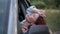 Side view face of happy beautiful woman sitting in car leaning on door looking up. Relaxed attractive Caucasian traveler