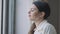 Side view face of relaxed young woman enjoying tea at lunch break looking out the window. Close-up portrait of happy