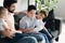 side view of father and sons reading book together