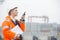 Side view of female engineer using walkie-talkie in shipping yard