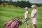 side view of female golfers with golf equipment walking