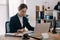 side view of female lawyer doing paperwork at workplace with laptop