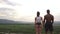 Side view of a fitness muscular mixed race couple watching the sunrise in mountains together. Beauty and perfection of