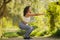 Side view of fitness woman enjoys outdoor workout while squats