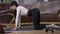 Side view flexible sportswoman warming up waist muscles in slow motion. Wide shot fit motivated confident Caucasian