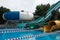 Side view of fun slides in aquapark. Summer vacation entertainment ideas. Colorful slide variety and turquoise swimming pool at a