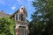 Side view of gabled tower and porch of an old house from the nineteenth century in historic Sherbrooke Village in Nova Scotia.