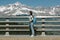 side view of girl with backpack standing near fence in majestic majestic mont