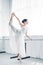 side view of graceful flexible young ballerina practicing ballet