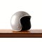 Side view of gray color retro style motorcycle helmet on natural wooden desk.Concept classic object white background