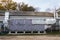 Side view of the gray industrial central conditioner with cooling coil and big condensing unit standing outdoor on the ground cove