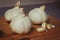 Side View Group Of Garlic Cloves Up Close  Wooden Chopping Board