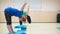 Side view A group of three girls doing exercises - stretch hands rubber blue expanders.