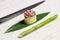 Side view of Gunkan Maguro Green sushi served on bamboo leaf near Japanese knife and bamboo plant stick