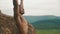 Side view of handsome african american bodybuilder stretching outdoor. Mountain landscape background