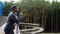 Side view of handsome thoughtful young man standing on balcony terrace and drinking coffee leaning on railing of office