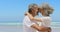 Side view of happy active senior African American couple embracing each other on the beach 4k