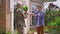 Side view happy teenage son giving bouquet of flowers to military mother hugging parent in sunshine in slow motion