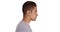 Side view of Hispanic man with cool undercut standing with white background